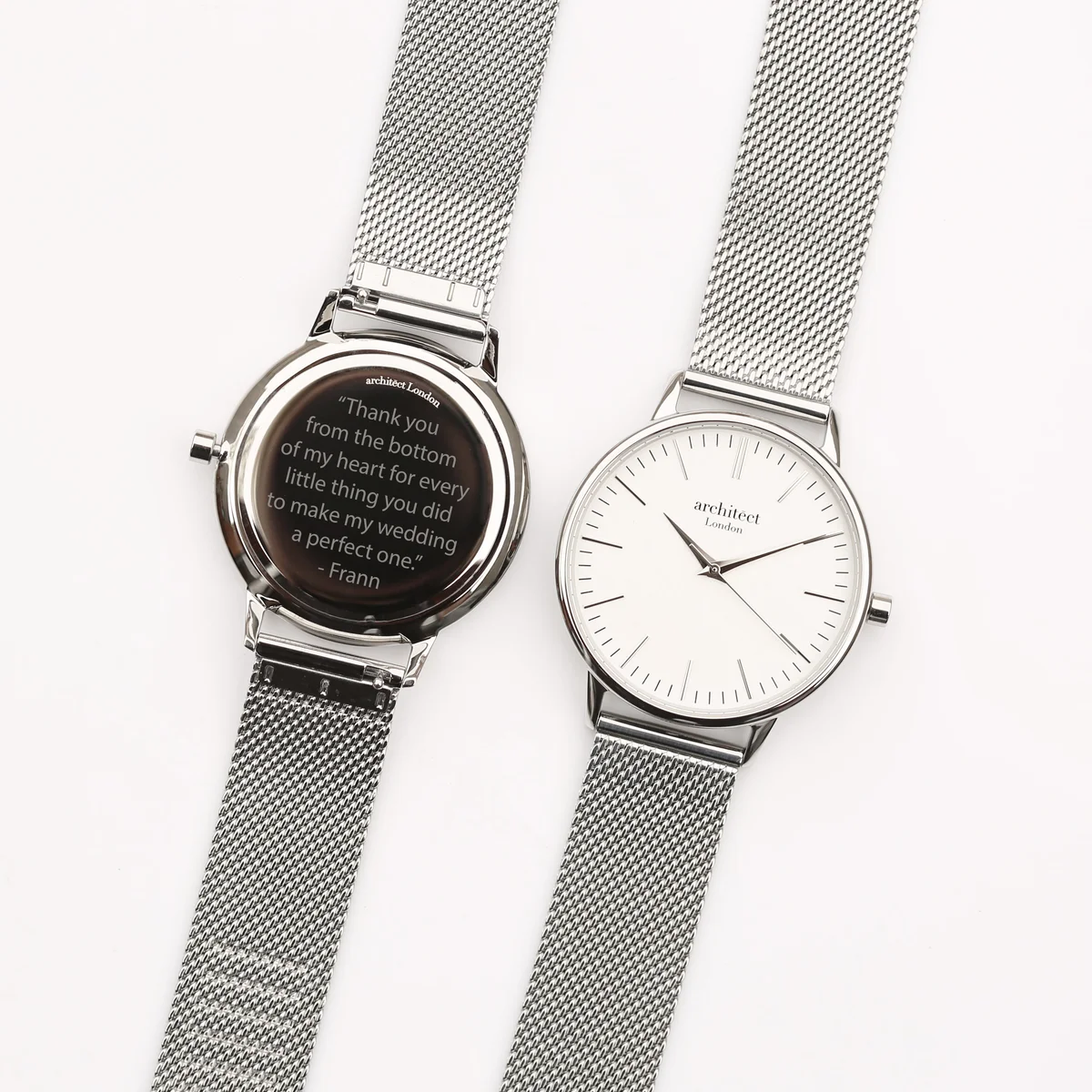 Ladies silver mesh watch with silver bezel and minimalist white dial, displayed on a white background