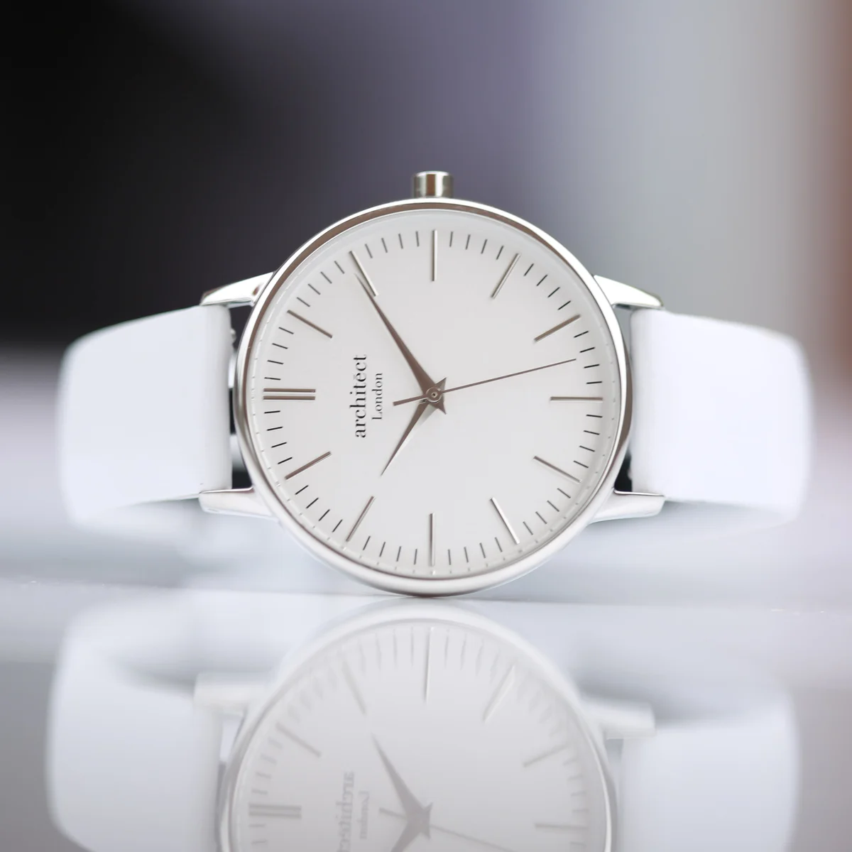 Ladies Blanc quartz movement watch with silver bezel, white genuine leather strap, and modern font engraving on back
