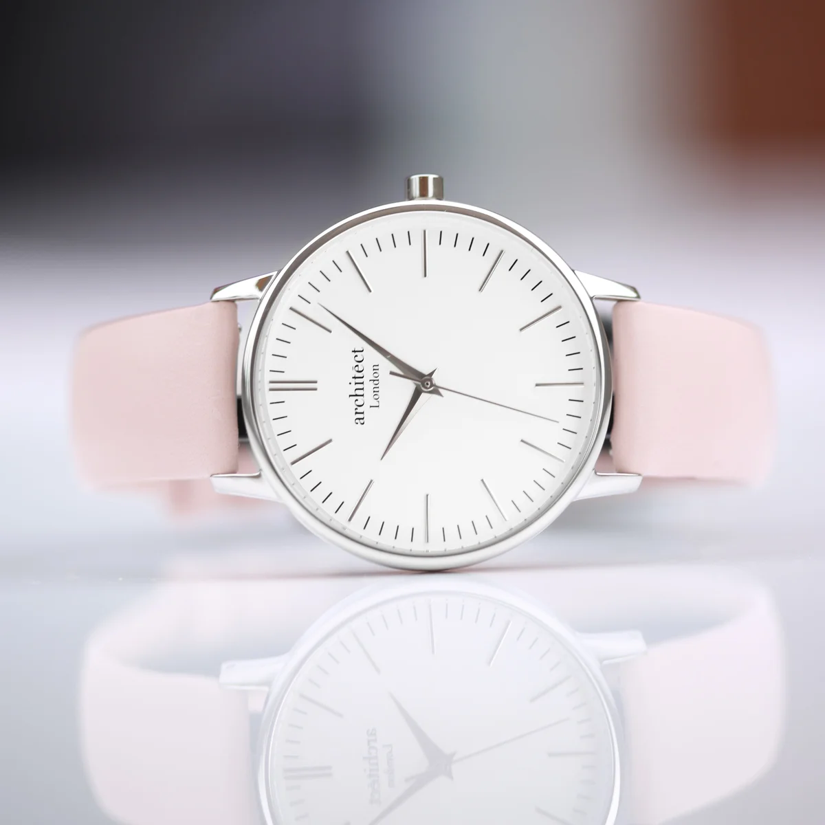 Engraved ladies watch with silver bezel, light pink leather strap, and personalized handwriting engraving on the back