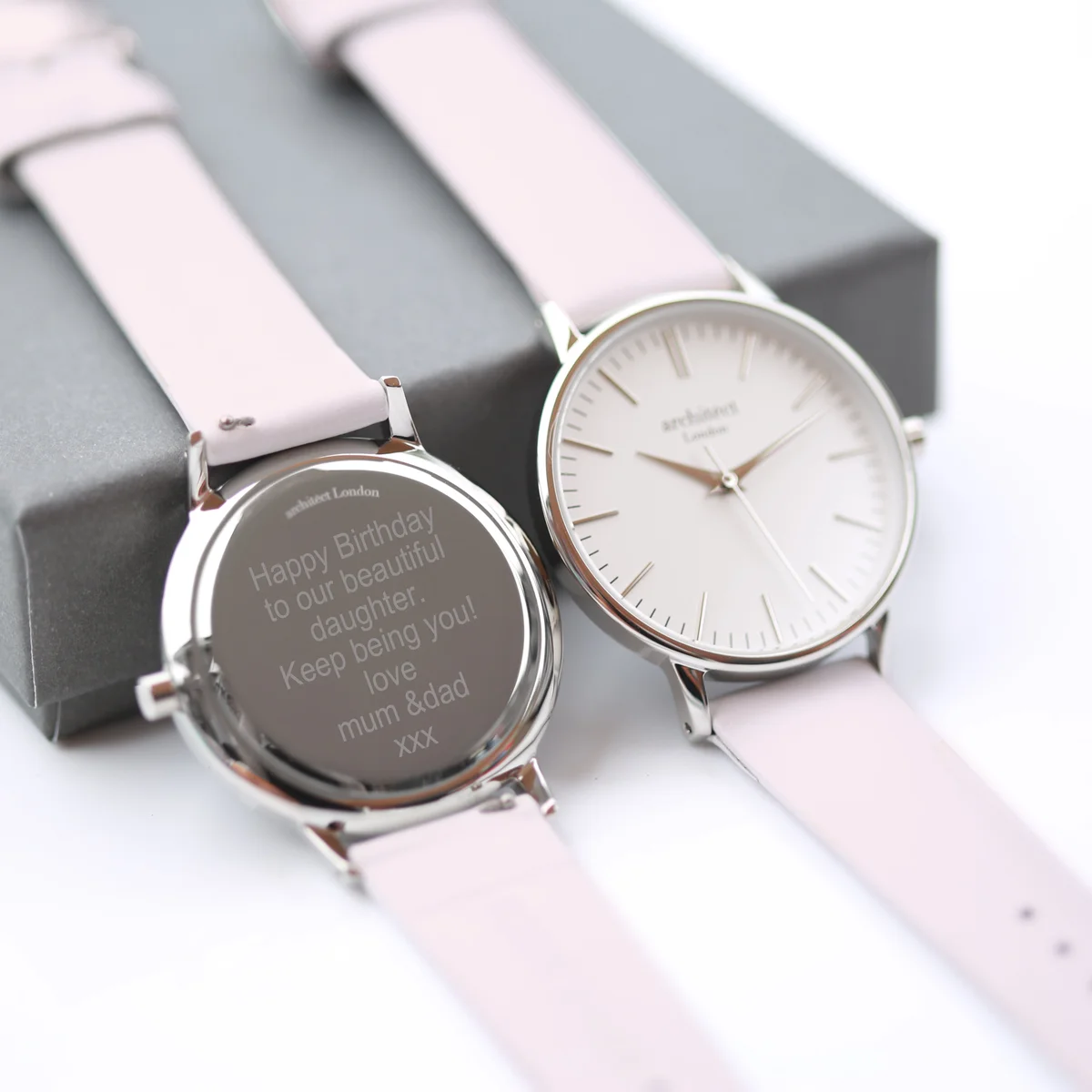 Personalised ladies watch with silver bezel, light pink leather strap, modern font engraving on back, minimalist dial design