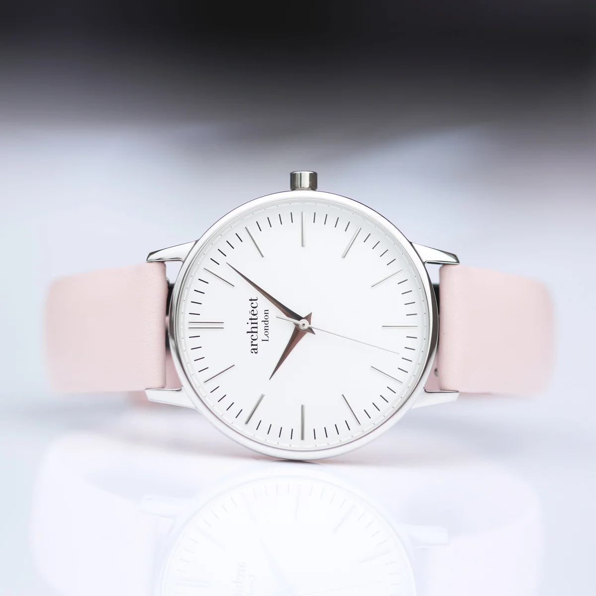 Ladies Blanc watch with silver bezel, light pink leather strap, minimalist dial, and quartz movement watch mechanism