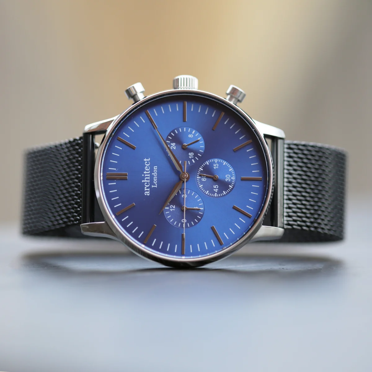 Men’s blue mesh strap watch with deep-space blue dial, black Milanese mesh band, and three chronograph subdials