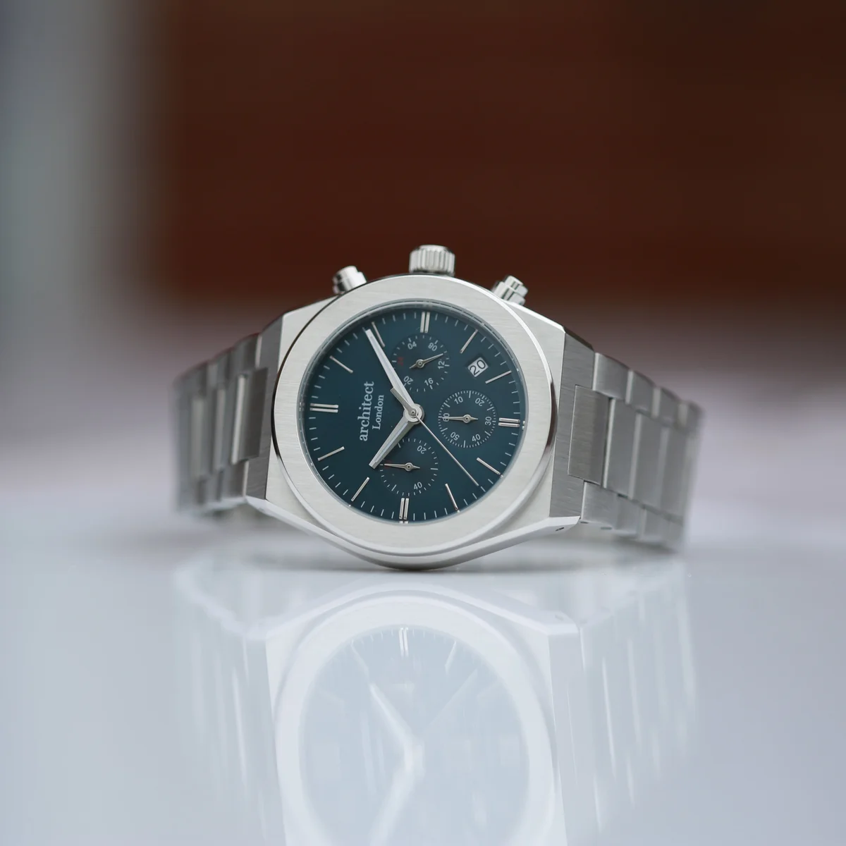Men’s Architect Orbix watch in deep space blue with stainless steel chronograph casing and silver bracelet on white background