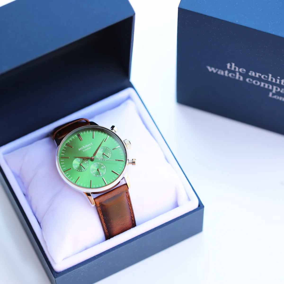 Men’s Envy Green Motivator contactless payment watch with walnut strap shown alongside mobile app payment watch interface on phone screen