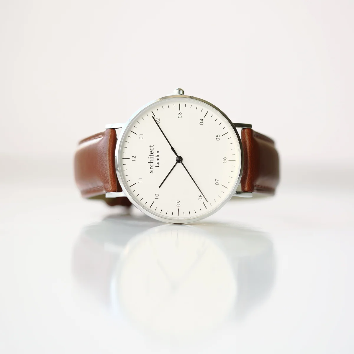 Men’s Architect Zephyr contactless payment watch with walnut strap shown alongside mobile app payment watch interface on smartphone screen