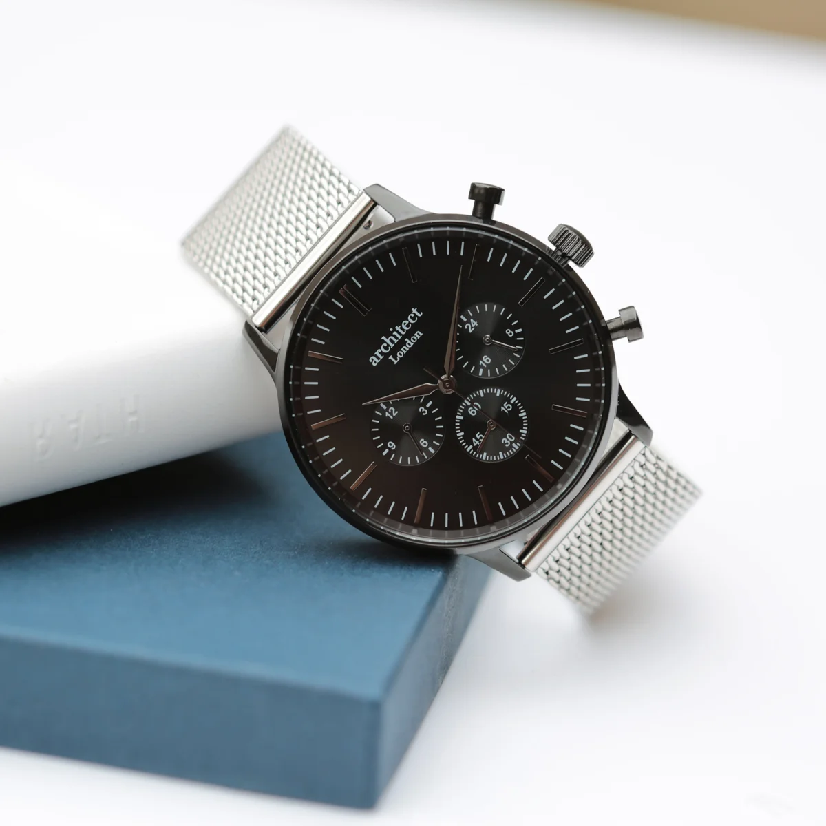 Men's personalised watch with black face, three chronograph dials, and silver Milanese mesh strap by Architect London