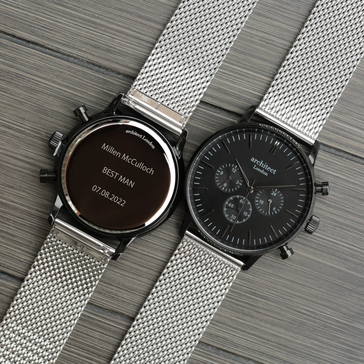 Black silver watch with polished stainless steel case, silver Milanese mesh strap, and three chronograph subdials on black dial