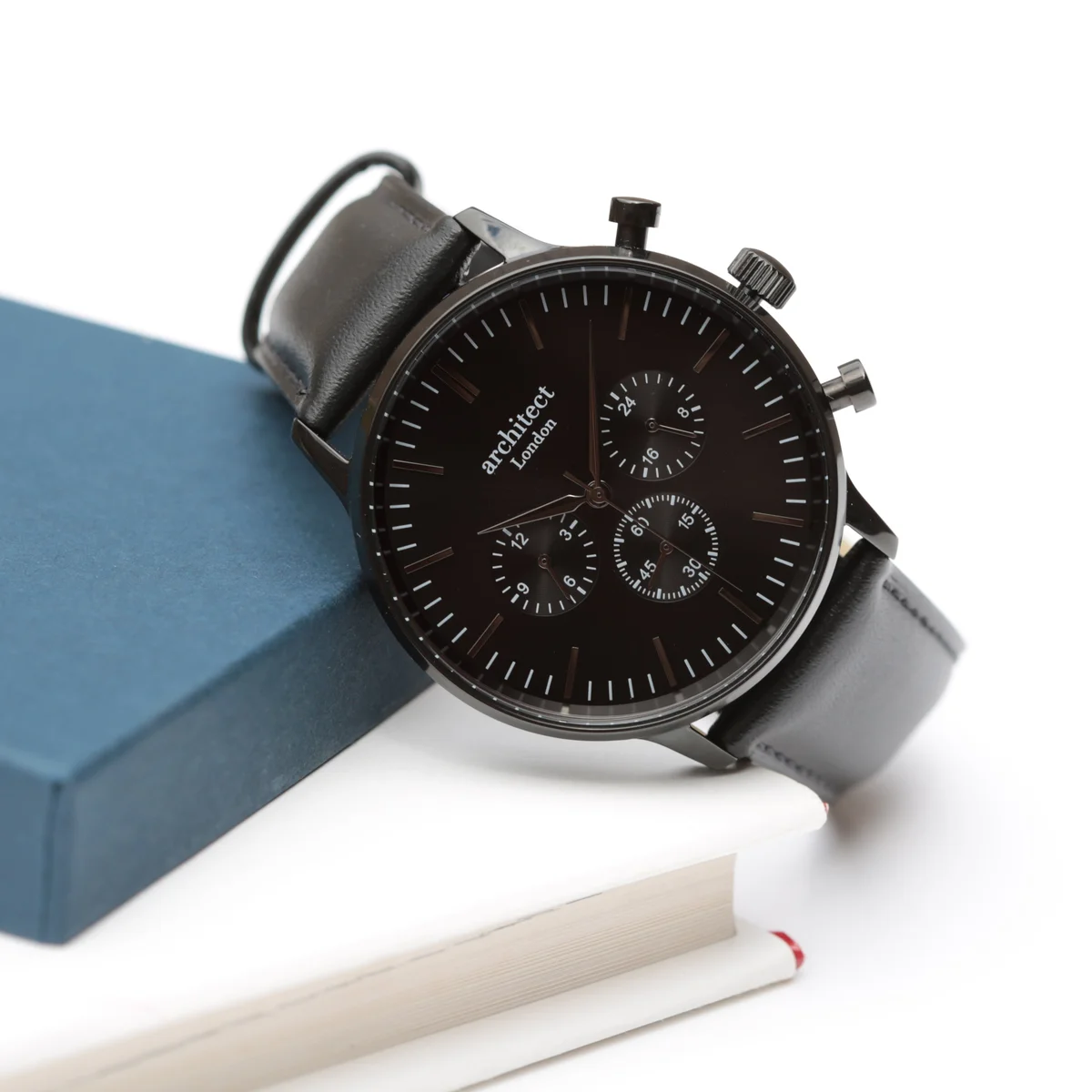 Men's personalised watch with black dial, three chronograph subdials, and black leather strap on white background