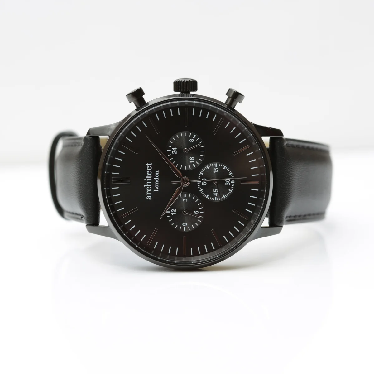 Black engraved men's watch with black leather strap and three chronograph subdials on black dial