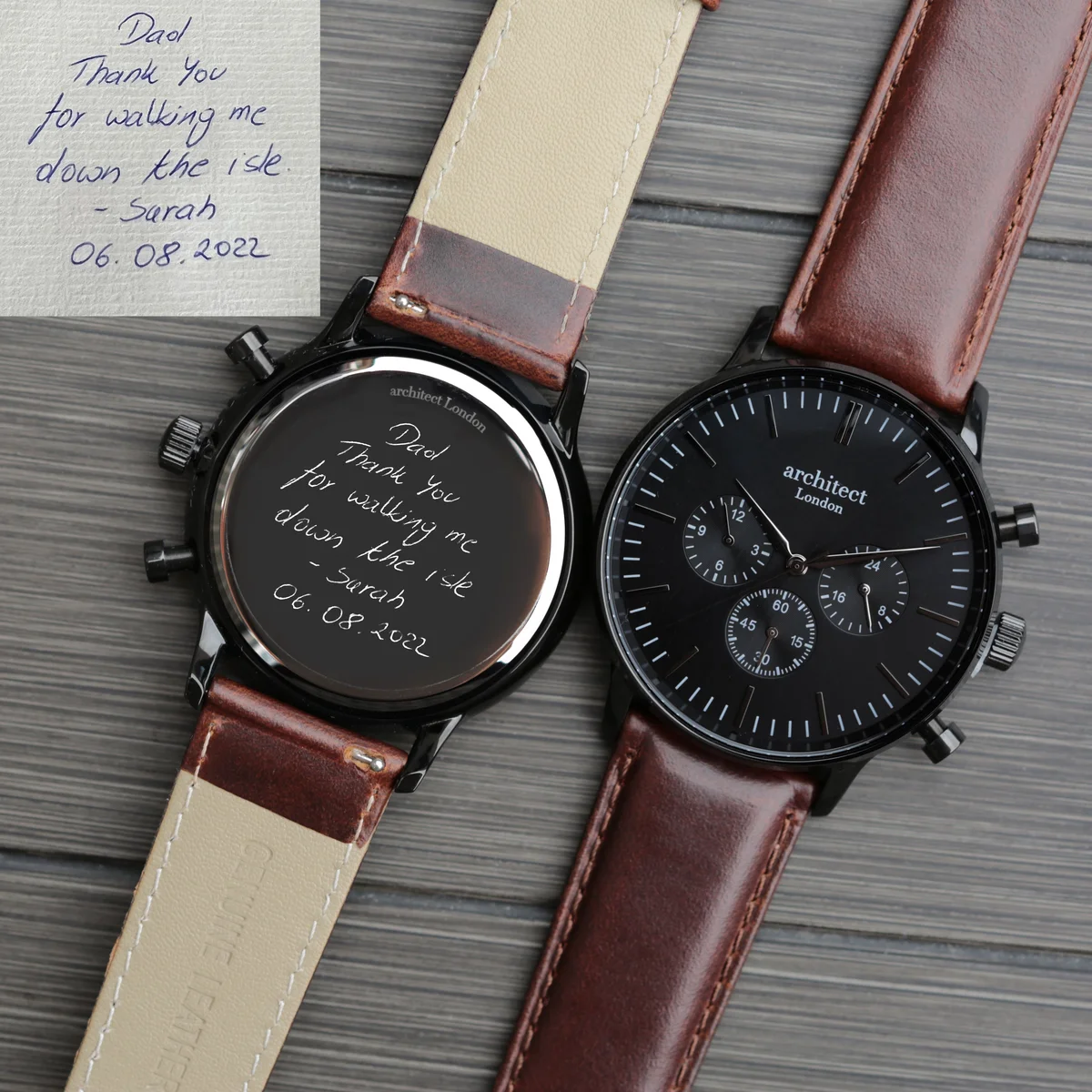 Black face watch with three chronograph subdials and dark brown walnut leather strap on white background