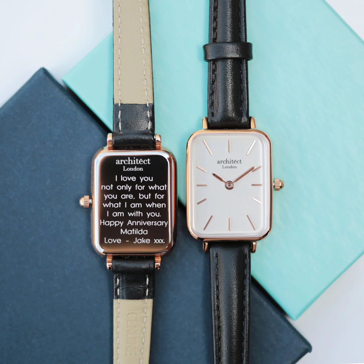 Ladies stainless steel watch with white dial, black leather strap, modern font engraving on back, elegant and minimalist design