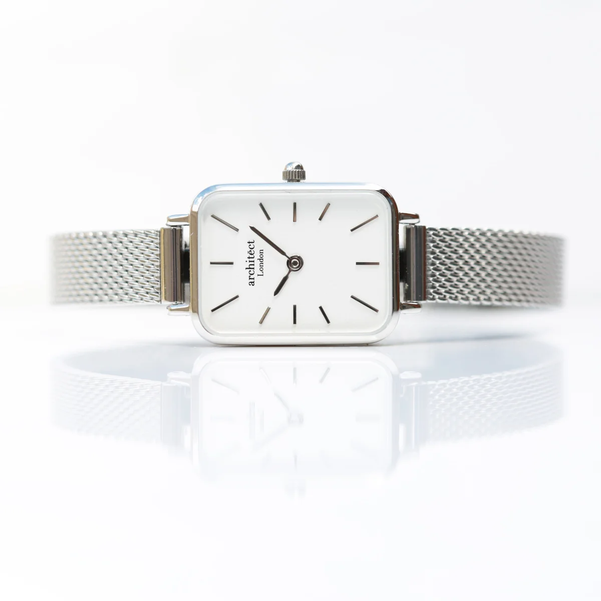 Ladies silver mesh strap watch with polished stainless steel case and minimalist dial, elegant for everyday wear