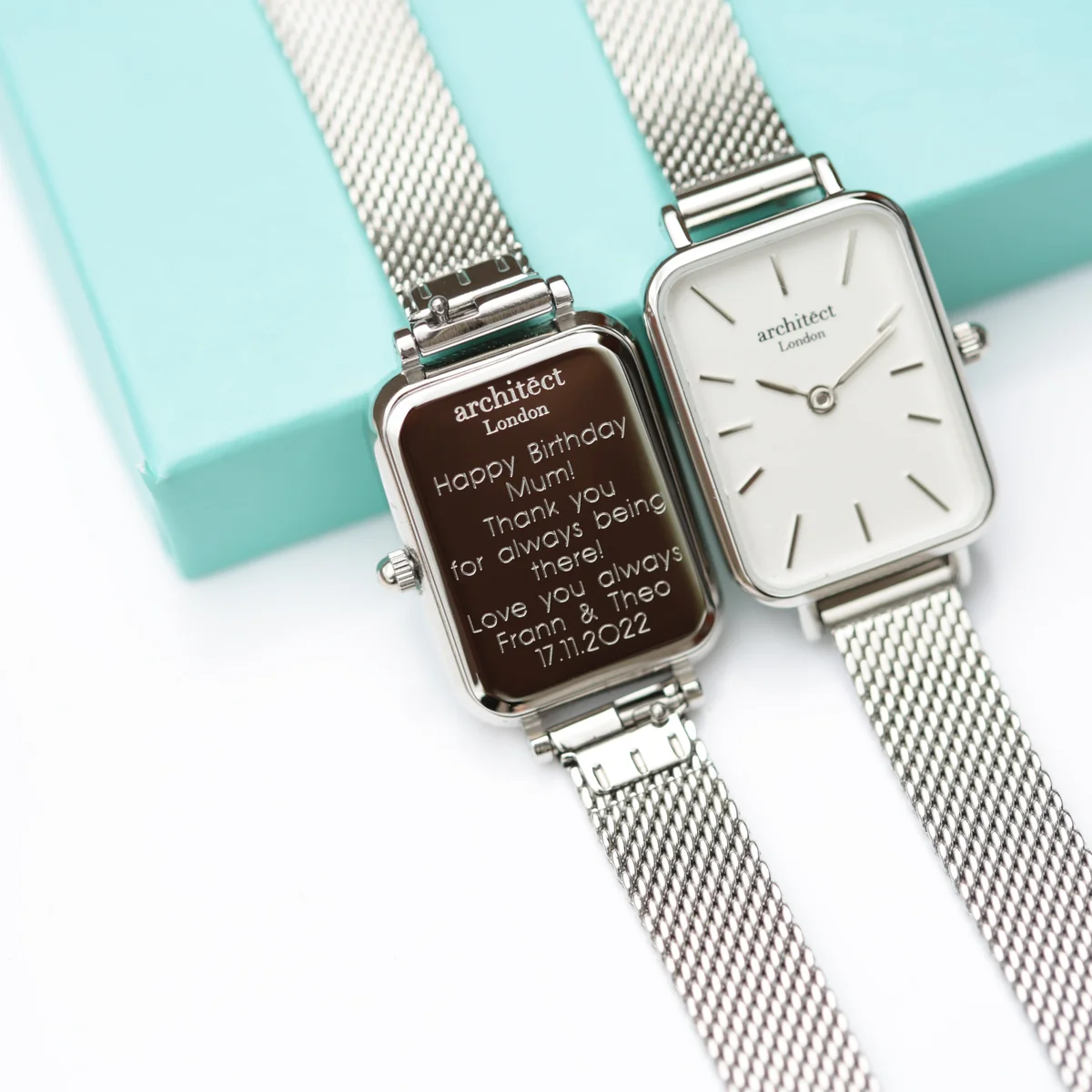 Silver mesh strap stainless steel ladies watch with minimalist dial and modern font engraving on the back case