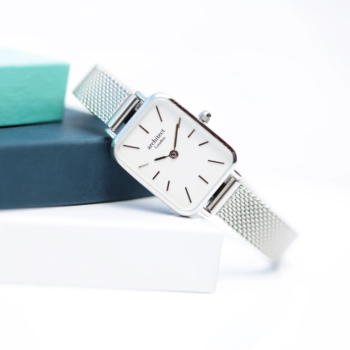 Ladies silver watch with polished stainless steel case and handcrafted silver mesh strap on white background