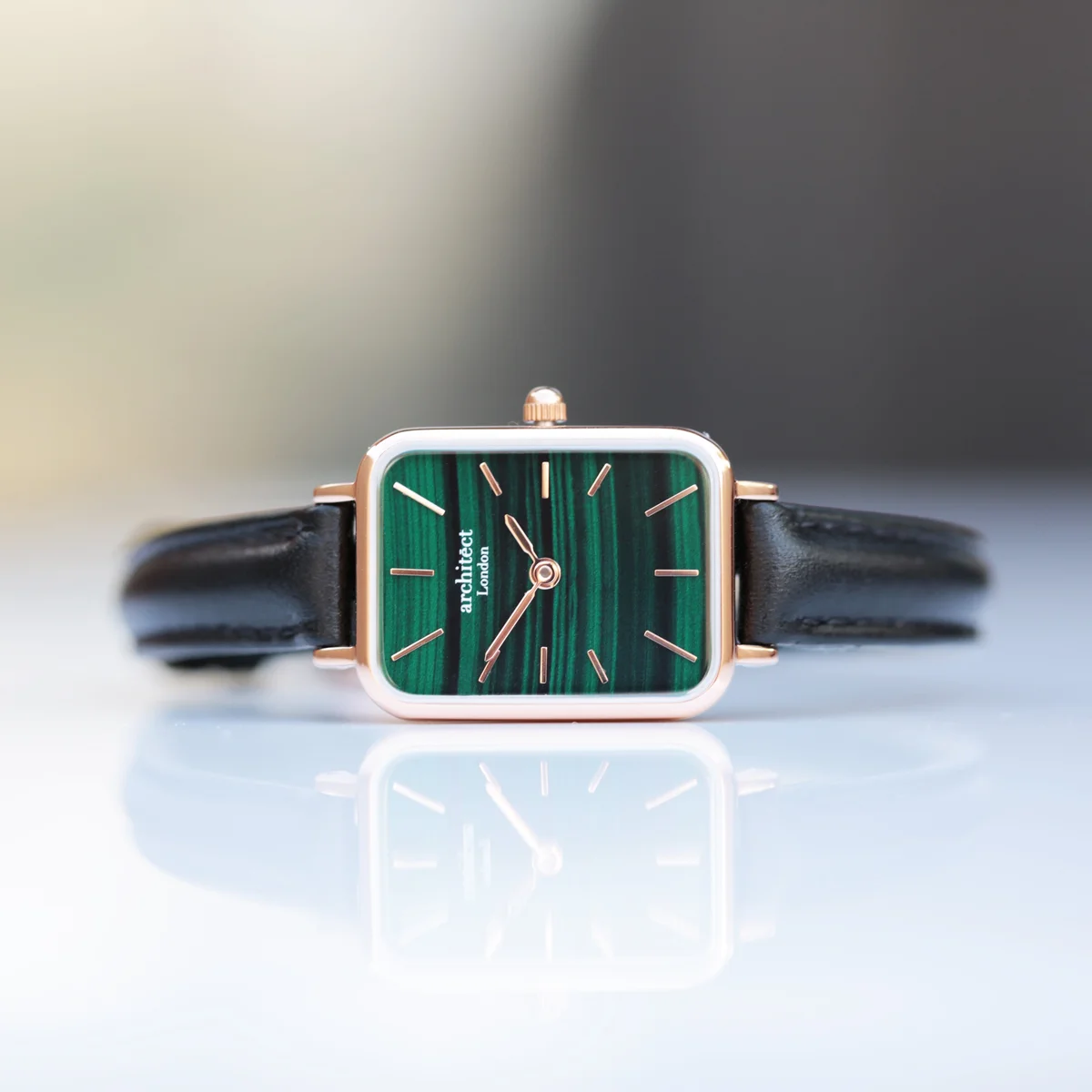 Ladies Architēct Lille watch with pine green leather strap, stainless steel case, and minimalist dial on white background