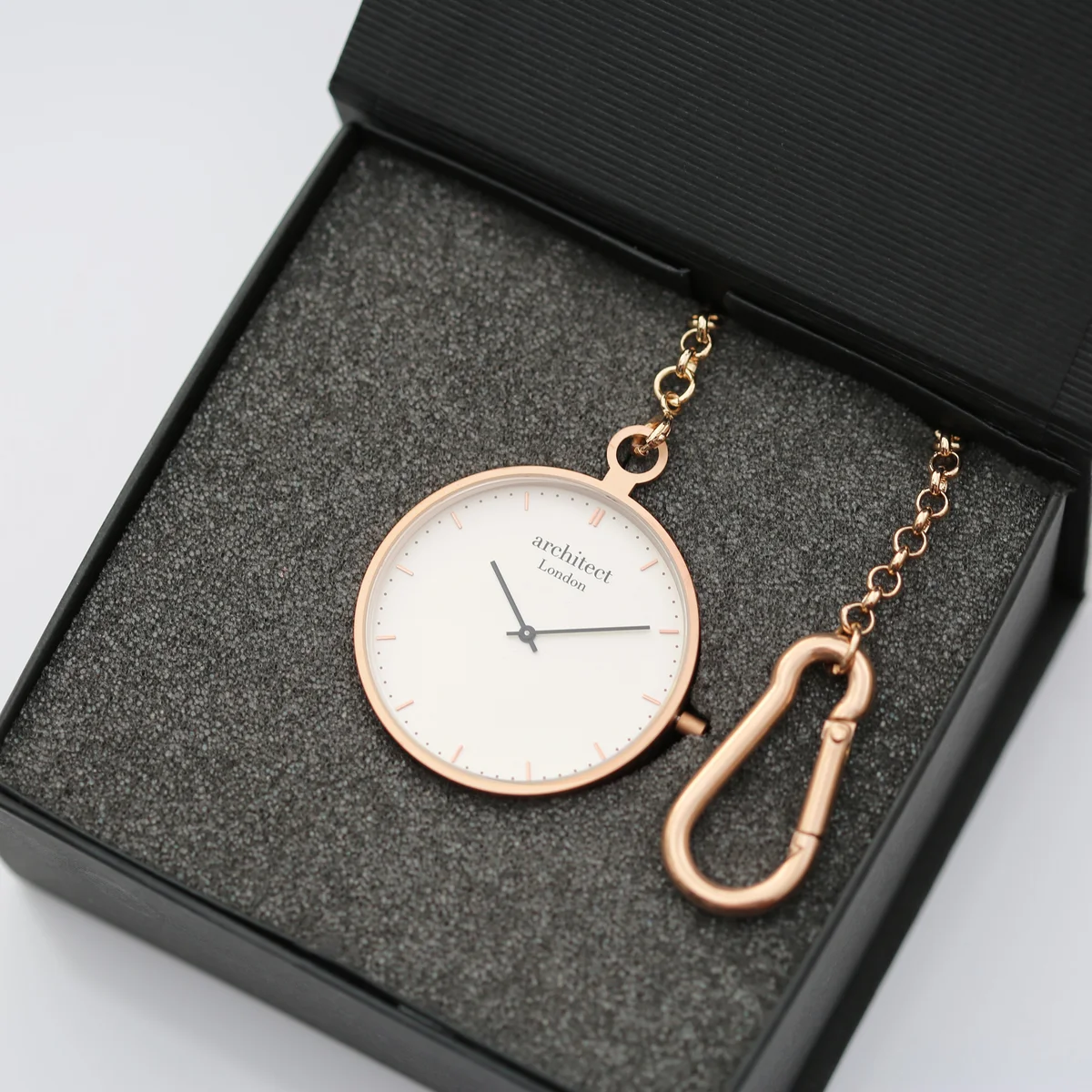 Rose gold modern pocket watch with sapphire glass watch face and brushed stainless steel case, open to show Swiss movement mechanism