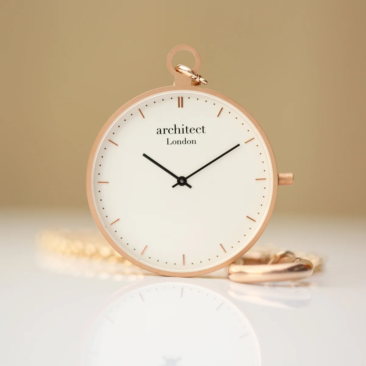 Modern pocket watch in brushed rose gold with clear dial, Swiss movement, and sapphire glass display cover