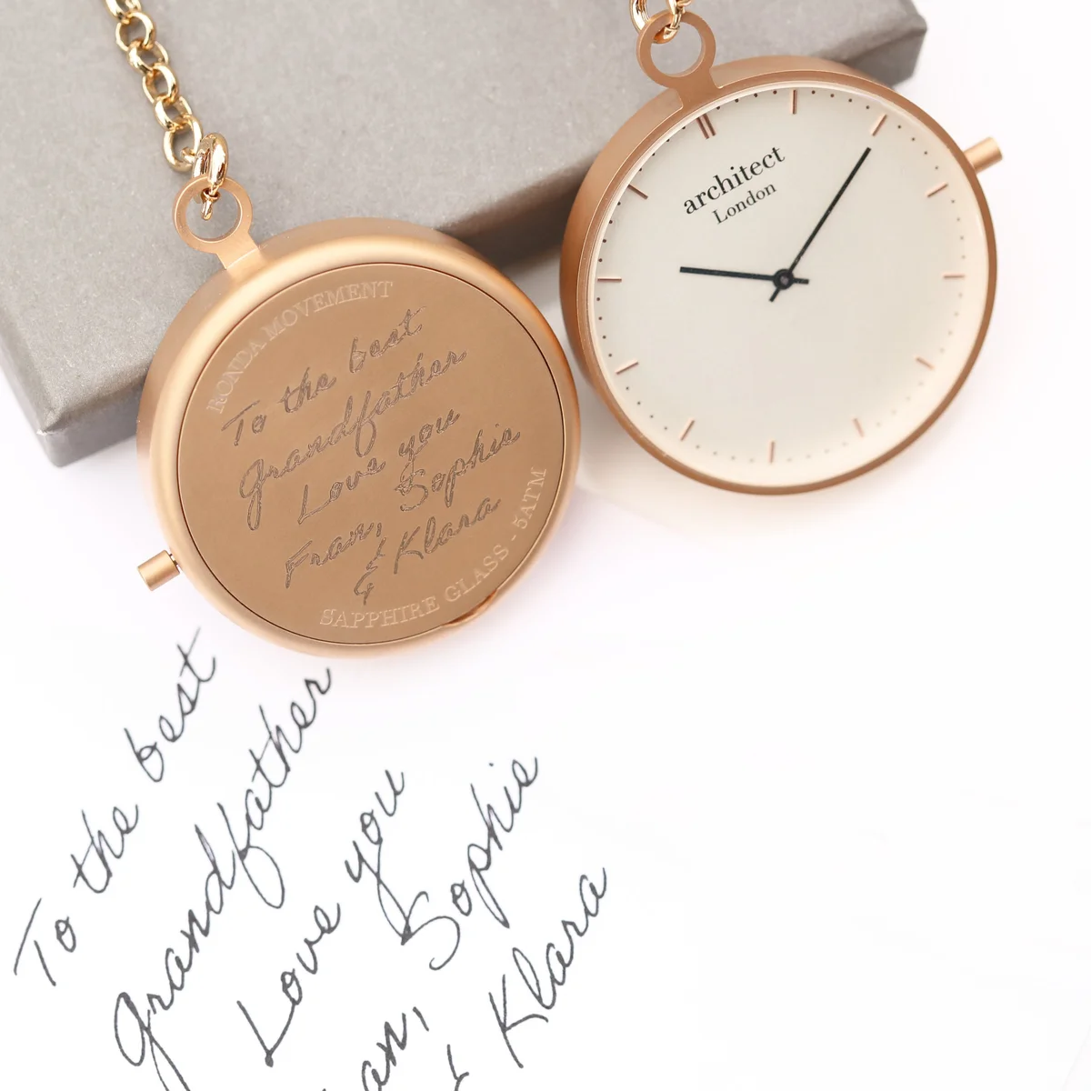 Modern rose gold stainless steel pocket watch with clear sapphire glass and elegant Swiss movement mechanism visible inside