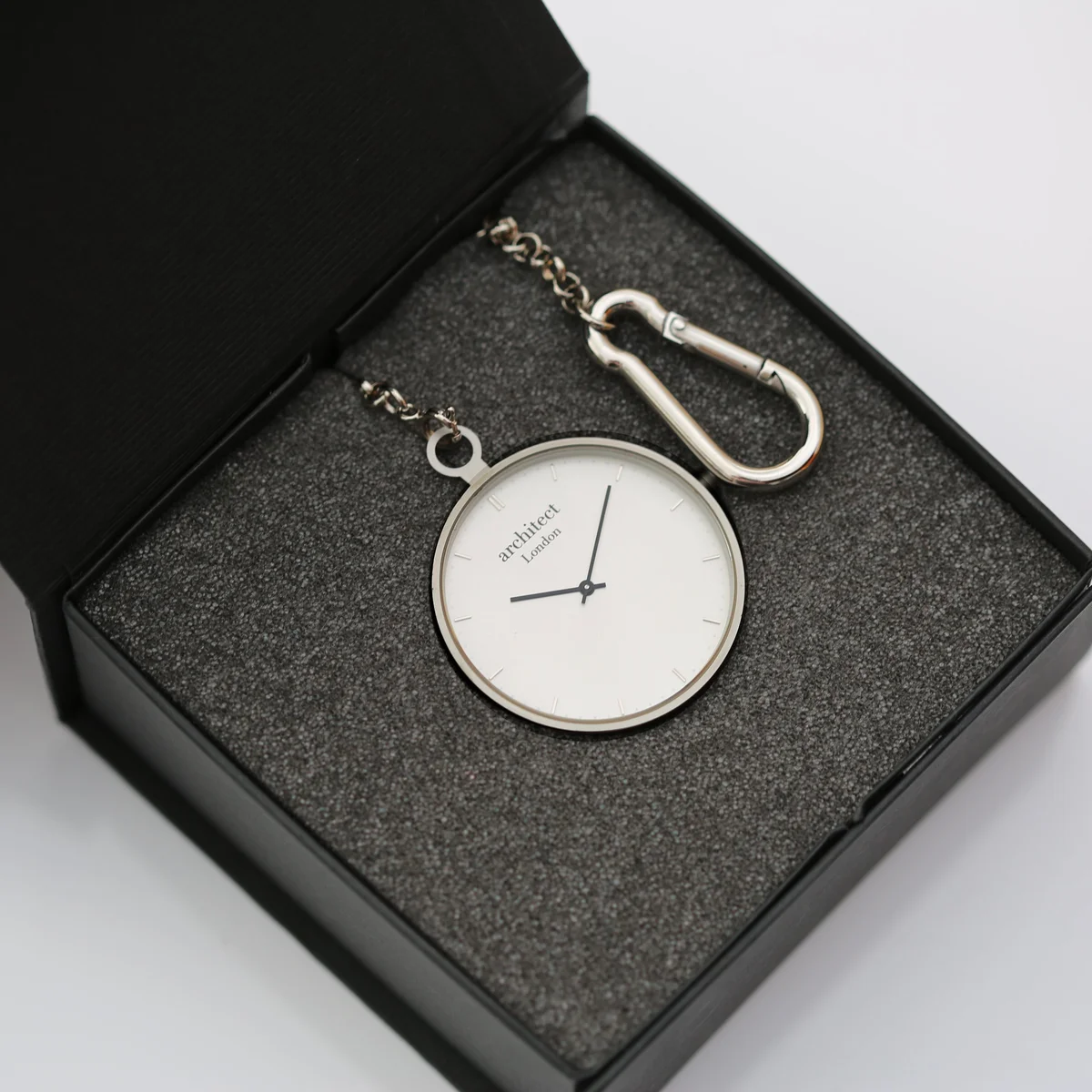 Open stainless steel pocket watch showing modern dial with Swiss movement and sapphire glass crystal