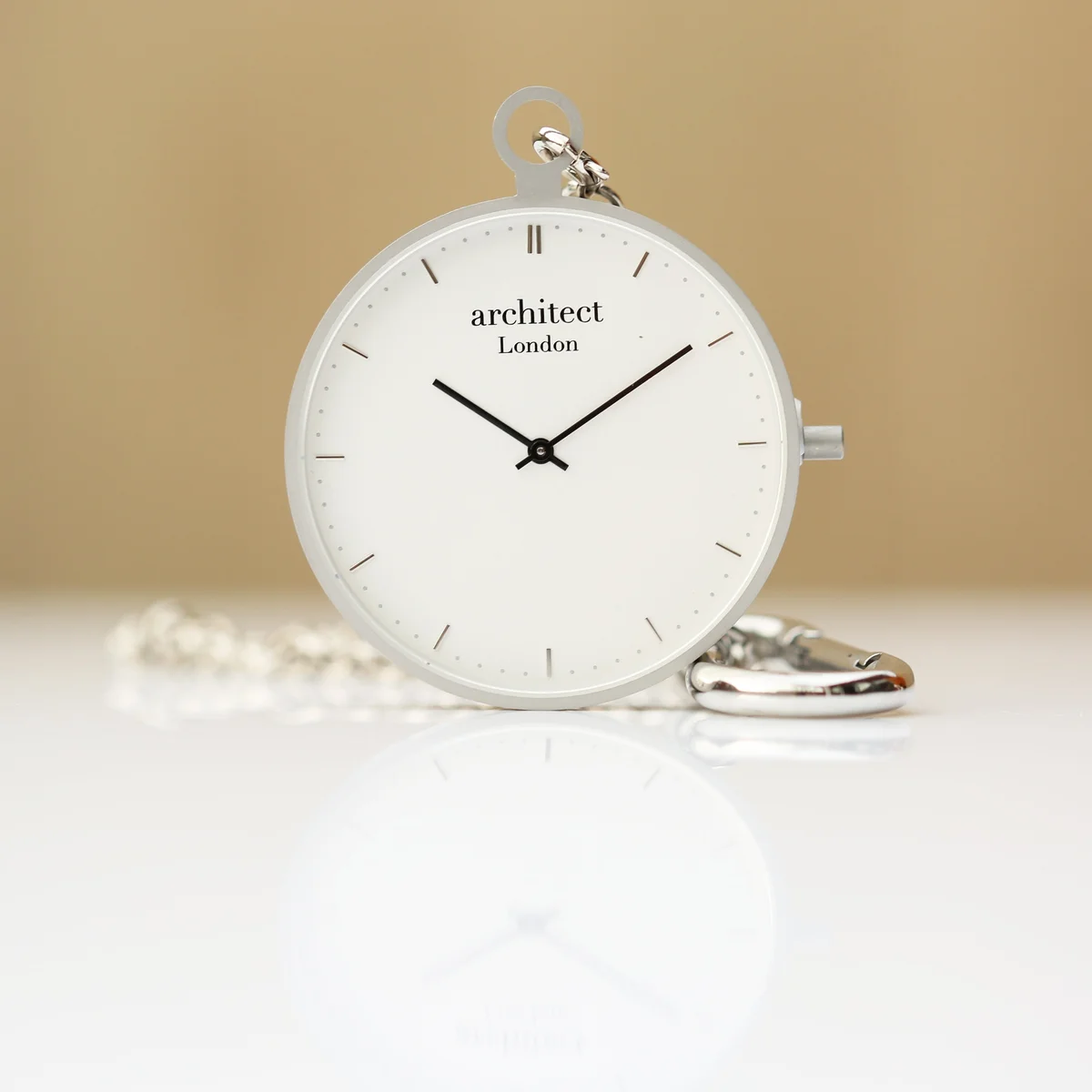 Modern pocket watch in brushed silver stainless steel with sapphire glass and Swiss movement, open to show white dial and hands