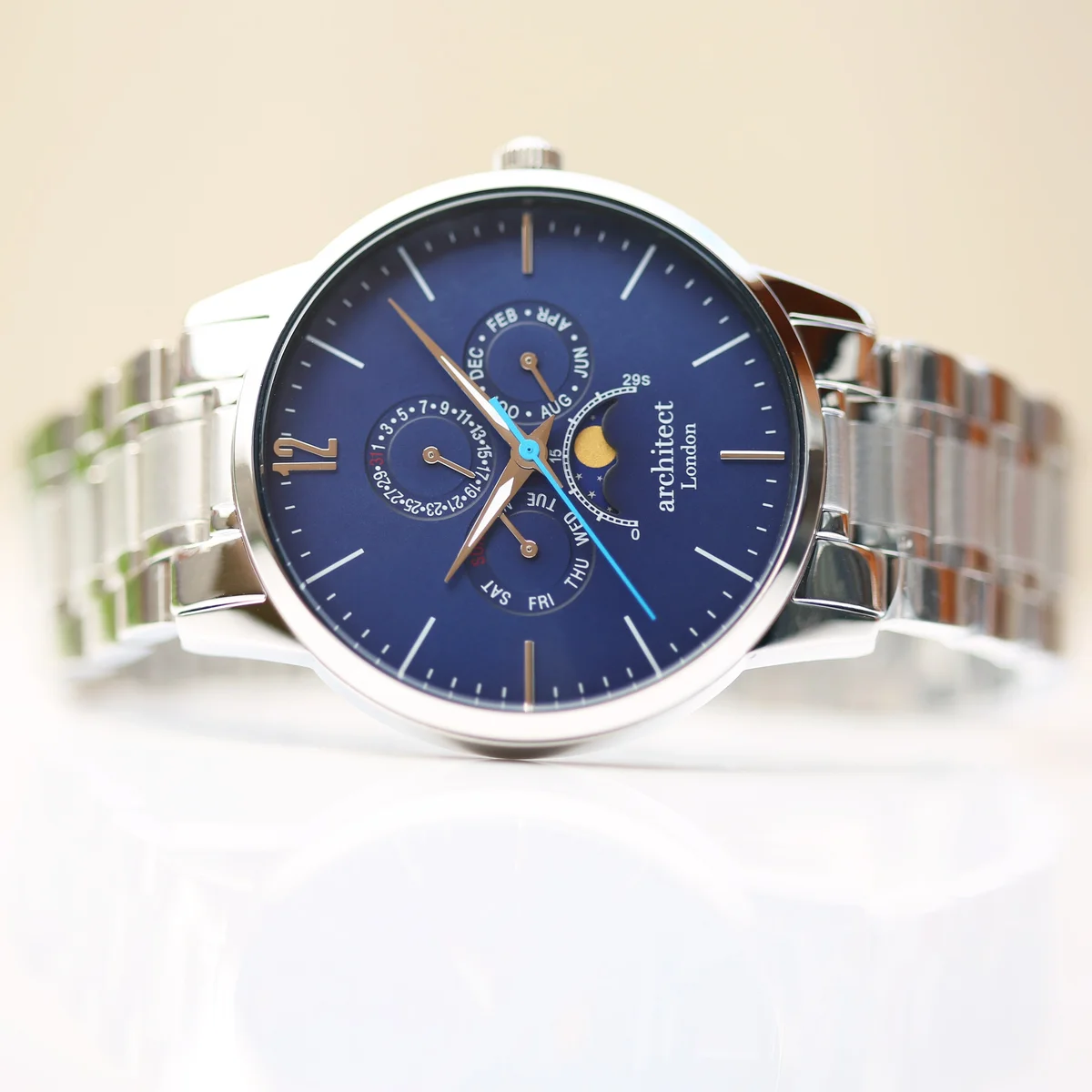 Men's moonphase watch with blue dial, silver stainless steel band, three chronograph subdials, and moonphase display
