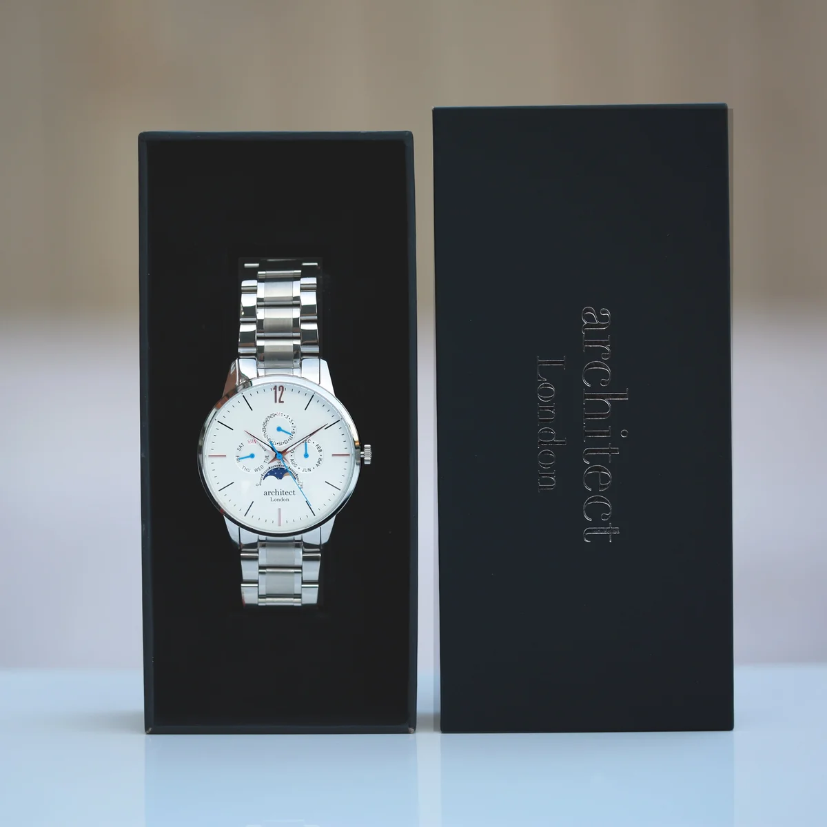 Men's moonphase watch with white dial, silver stainless steel strap, three chronograph subdials, and moonphase display