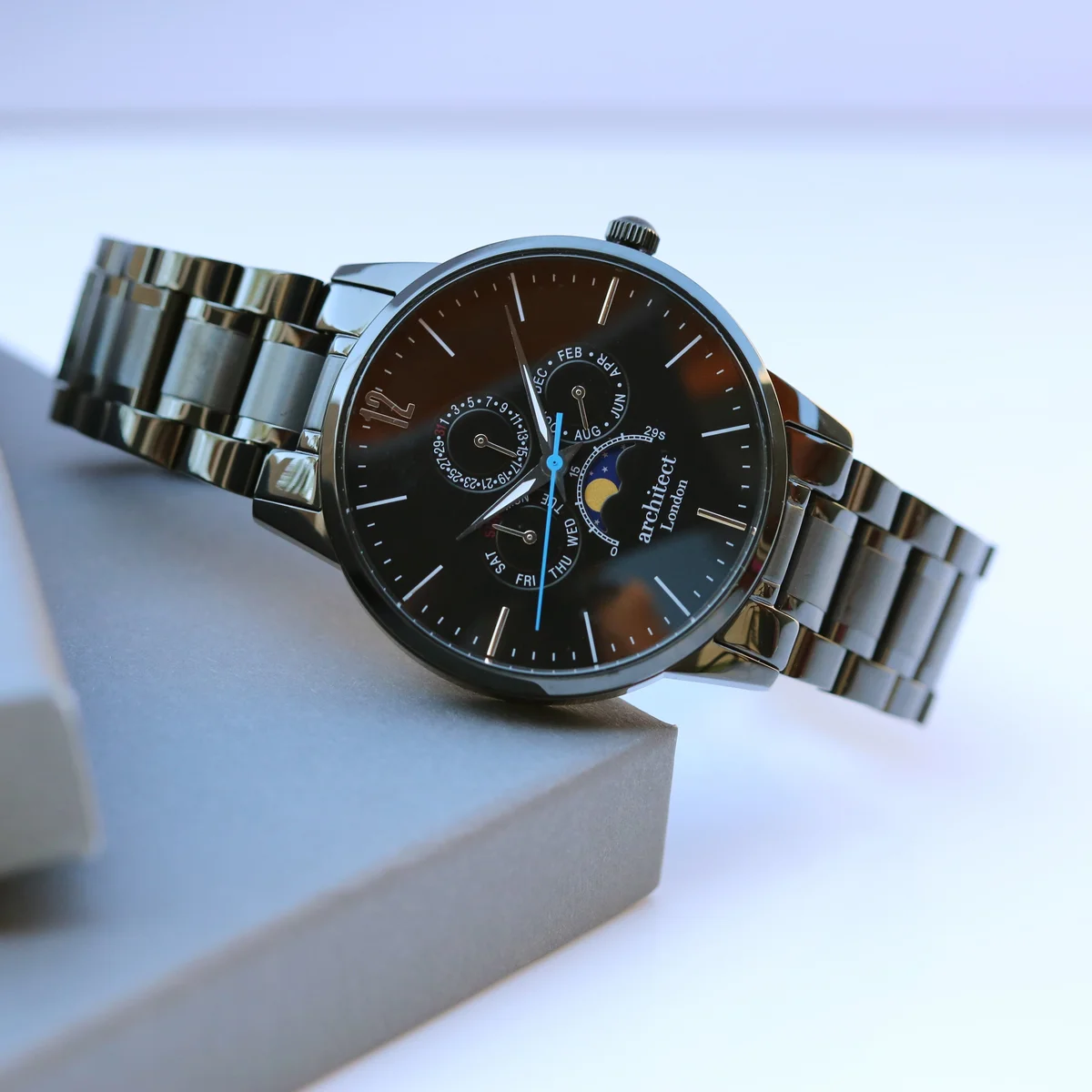 Men’s Architect Apollo black engraved moonphase watch with polished stainless steel case and black strap on white background