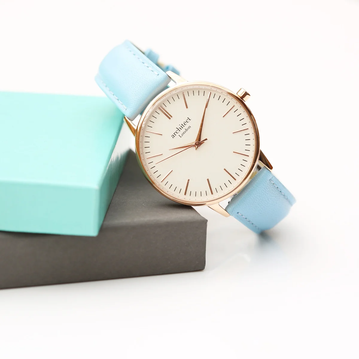 Ladies Architēct Blanc quartz movement watch with polished stainless steel case and light blue genuine leather strap on white background
