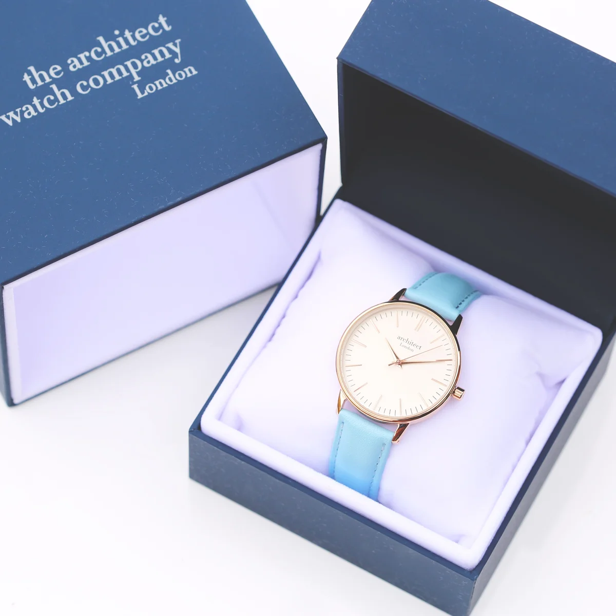 Ladies Architēct Blanc watch with light blue leather strap and stainless steel case, minimalist dial, and handwriting engraving on back