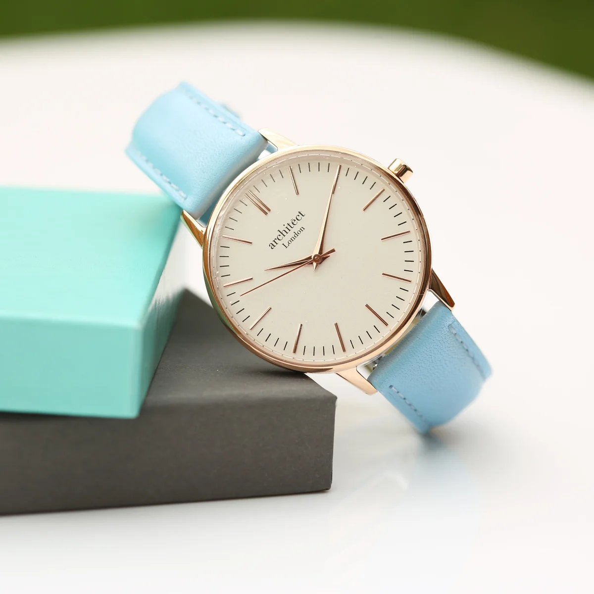 Ladies personalised watch with light blue genuine leather strap and stainless steel case, showing handwriting engraving on back