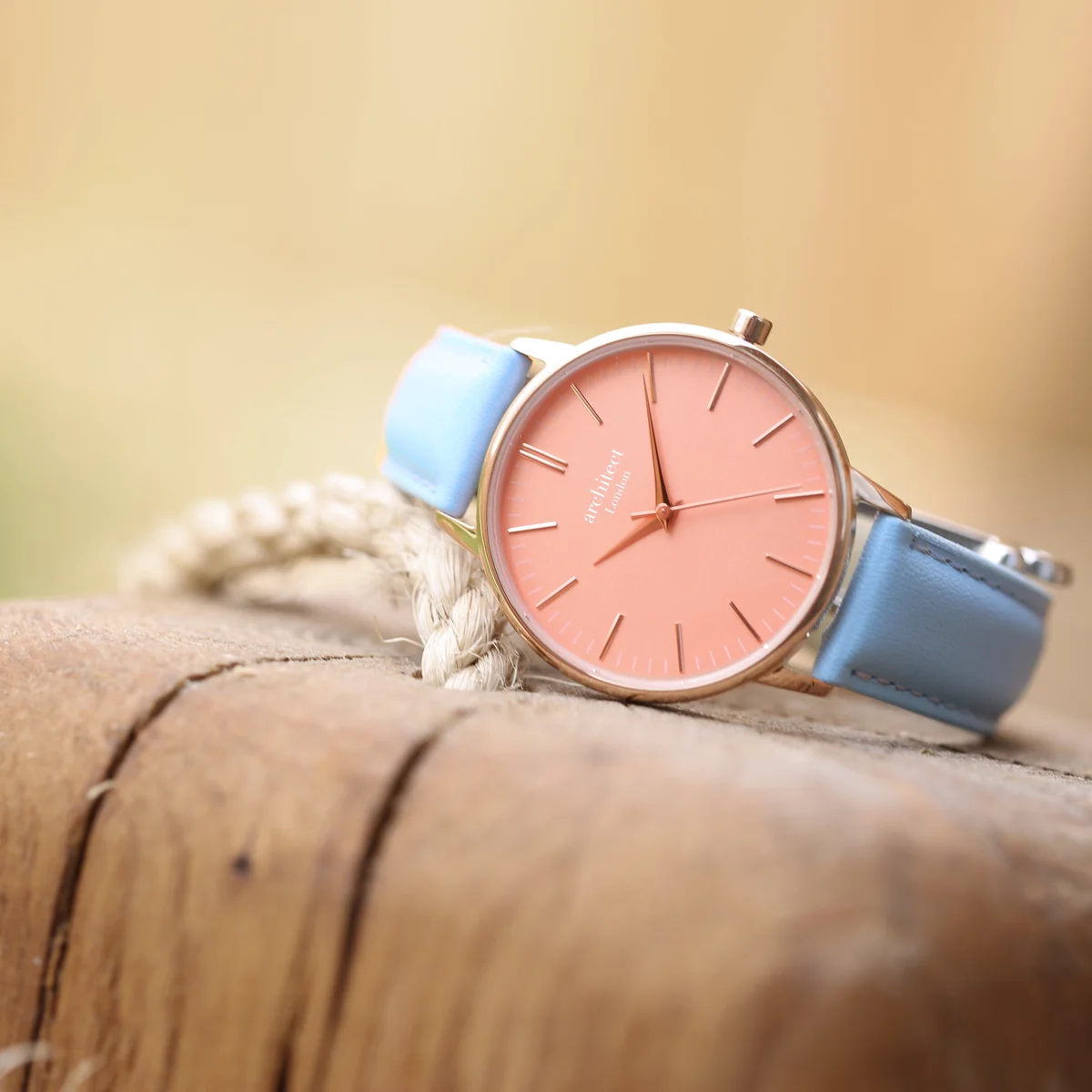 Ladies personalised watch with coral dial, light blue leather strap, stainless steel case, and handwriting engraving on back