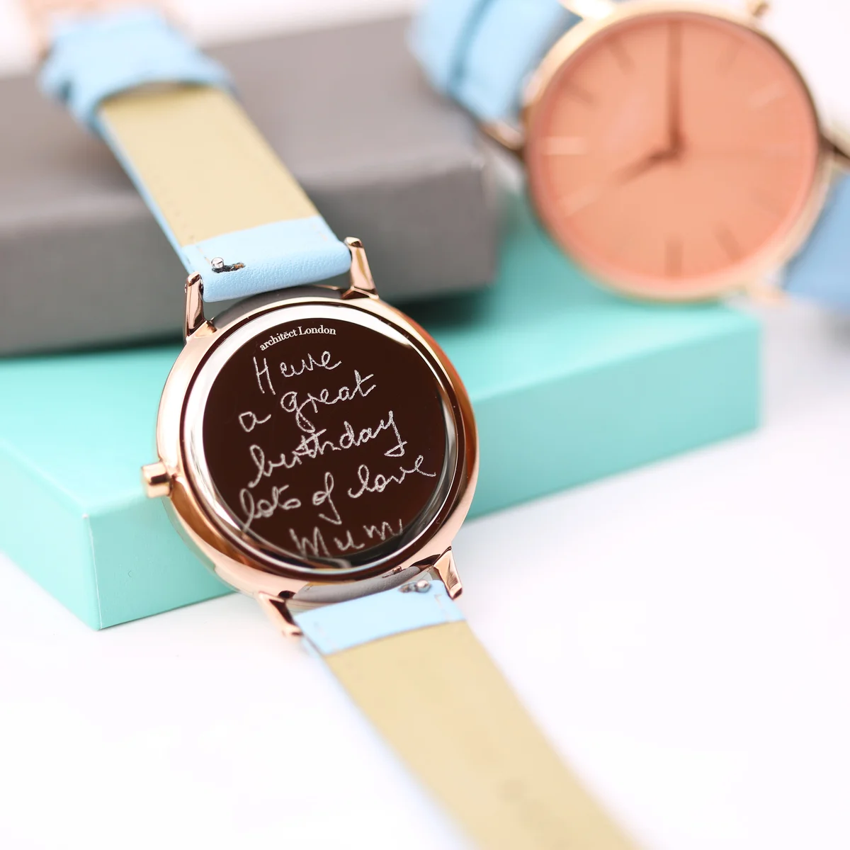 Ladies Architēct Coral quartz movement ladies watch with apricot coral dial and light blue genuine leather strap on wrist