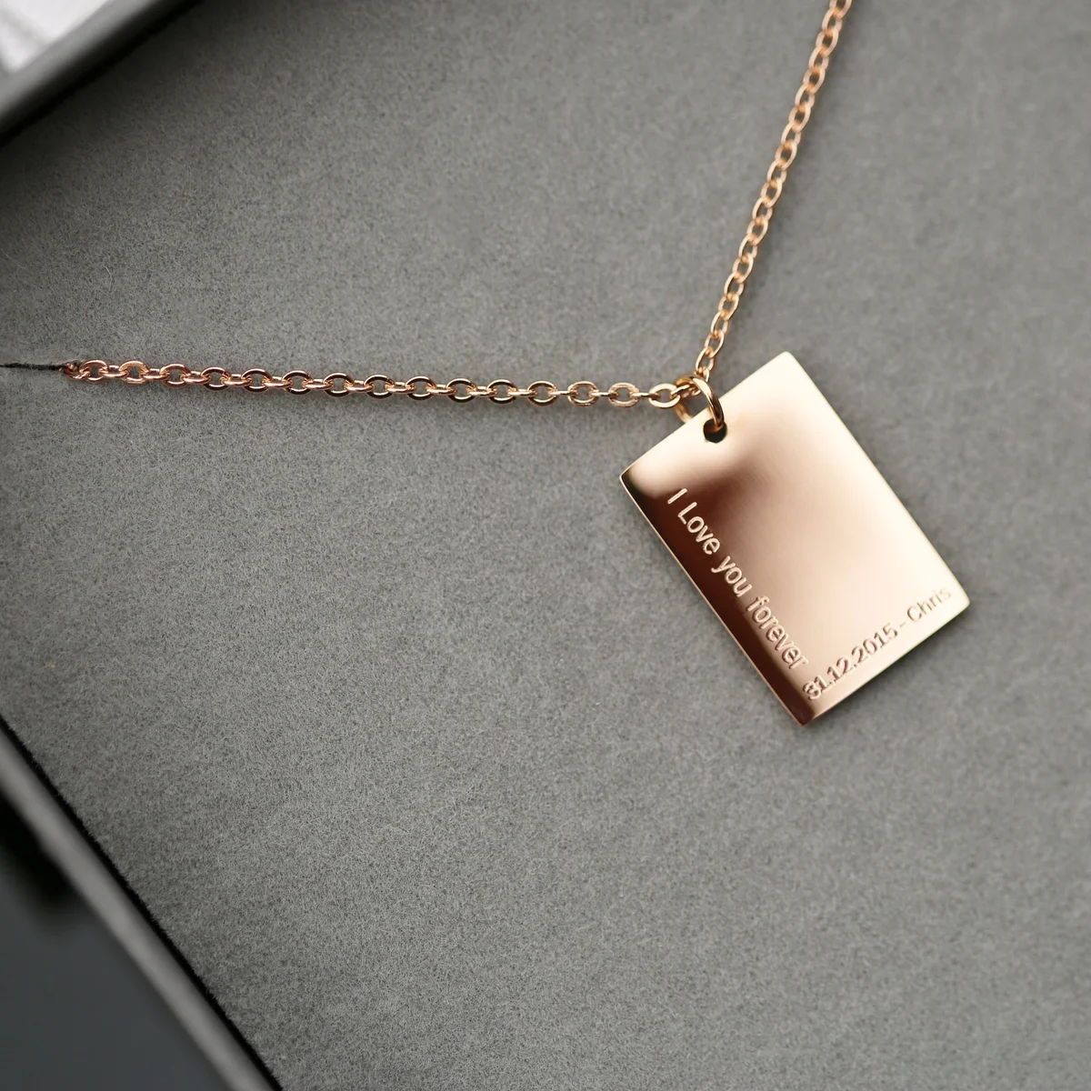 Dazzle personalised necklace in rose gold with modern font engraving displayed beside gift box included necklace packaging