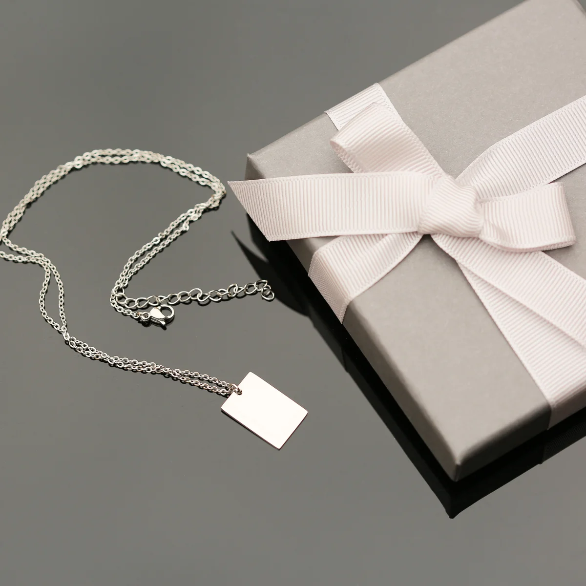 Personalised dazzle necklace in rose gold with modern font engraving on a 48cm chain displayed in a gift box
