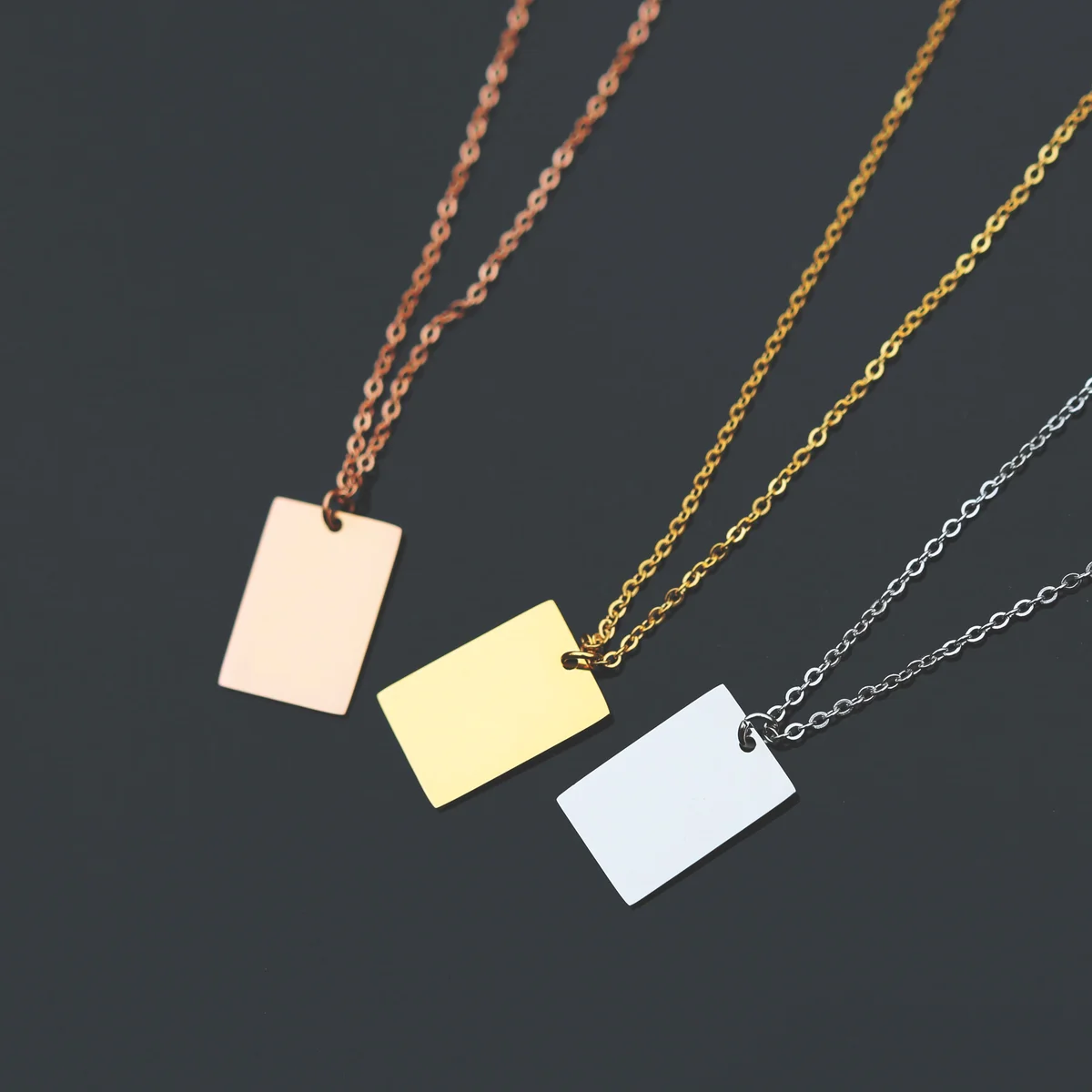 Personalised dazzle necklace in rose gold with modern font engraving on a 48cm chain displayed with gift box