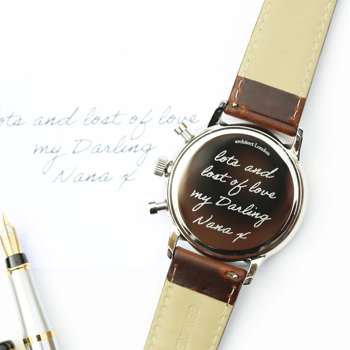 Engraved wristwatch with green dial, walnut brown leather strap, three chronograph subdials, and stainless steel case