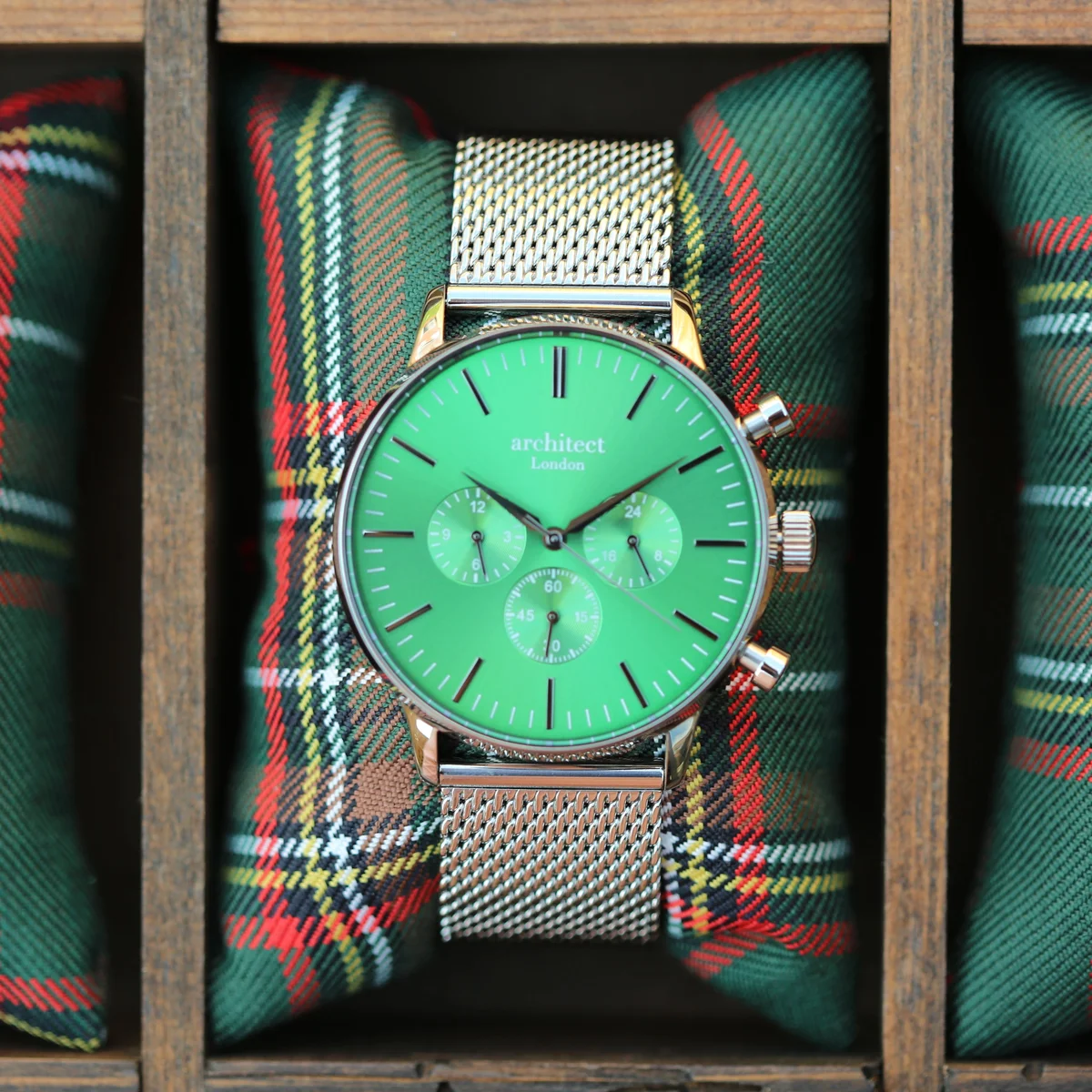 Personalised chronograph watch with green face, silver Milanese mesh strap, and three subdials on display