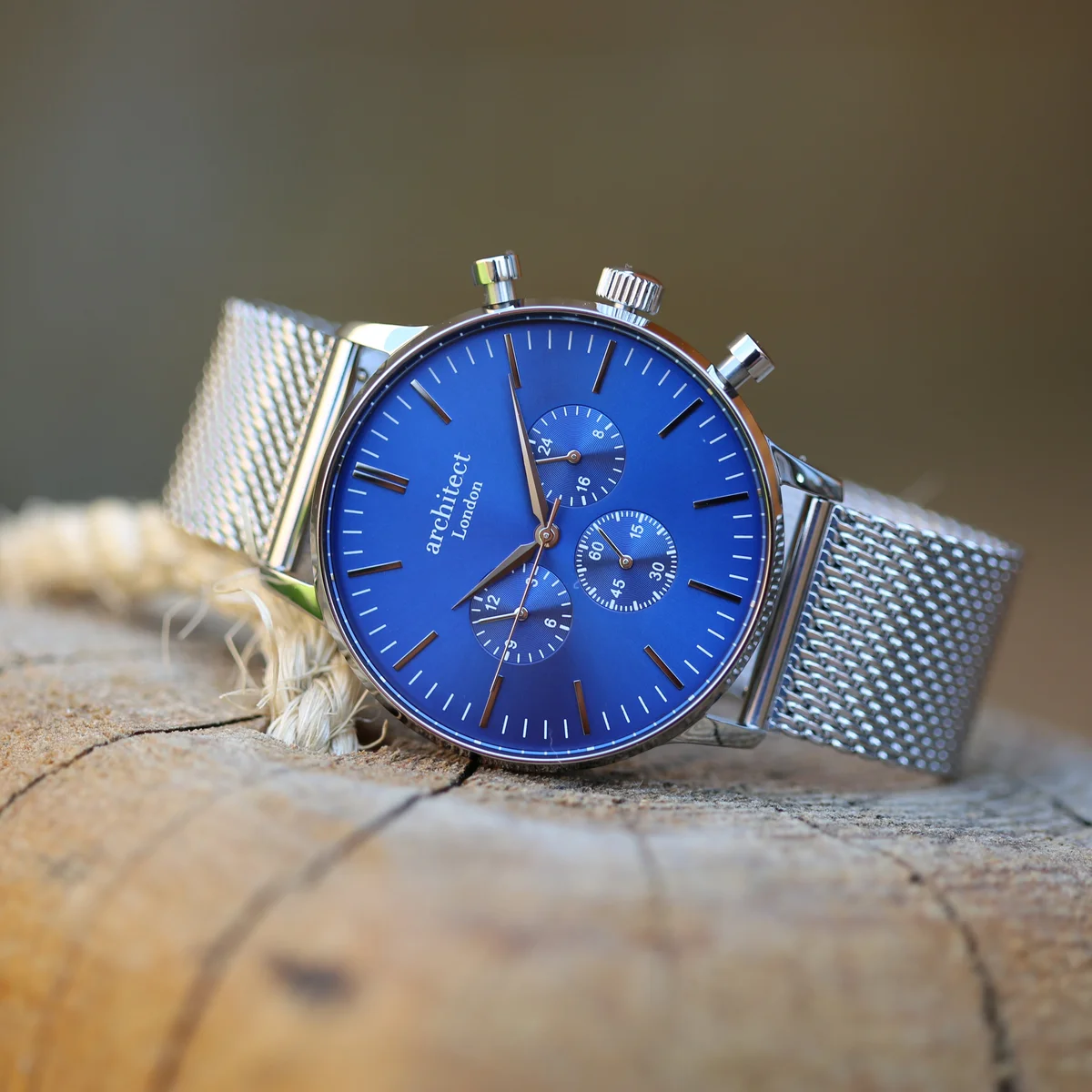 Personalised men's watch with deep-space blue dial, silver Milanese mesh strap, and three chronograph subdials displayed flat