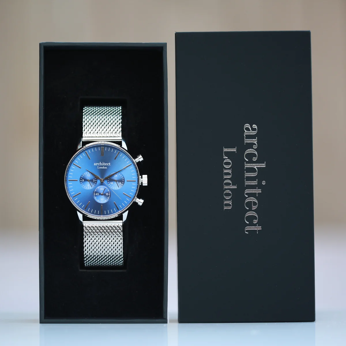 Personalised men's watch with deep-space blue dial, silver Milanese mesh strap, and three chronograph subdials on wrist