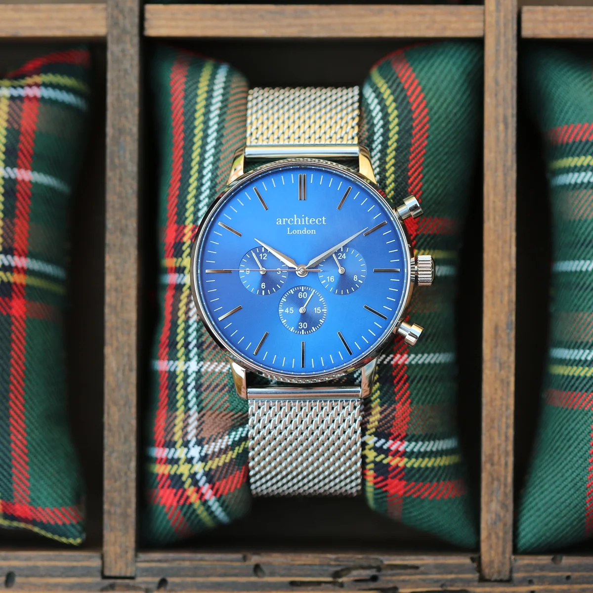 Men’s architect watch in deep-space blue with silver Milanese mesh strap and three chronograph subdials on white background
