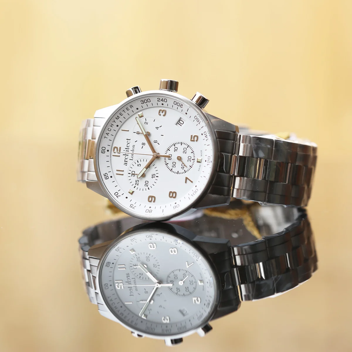 Swiss made engraved mens watch with stainless steel band and chronograph subdials, shown with luxury watch box open