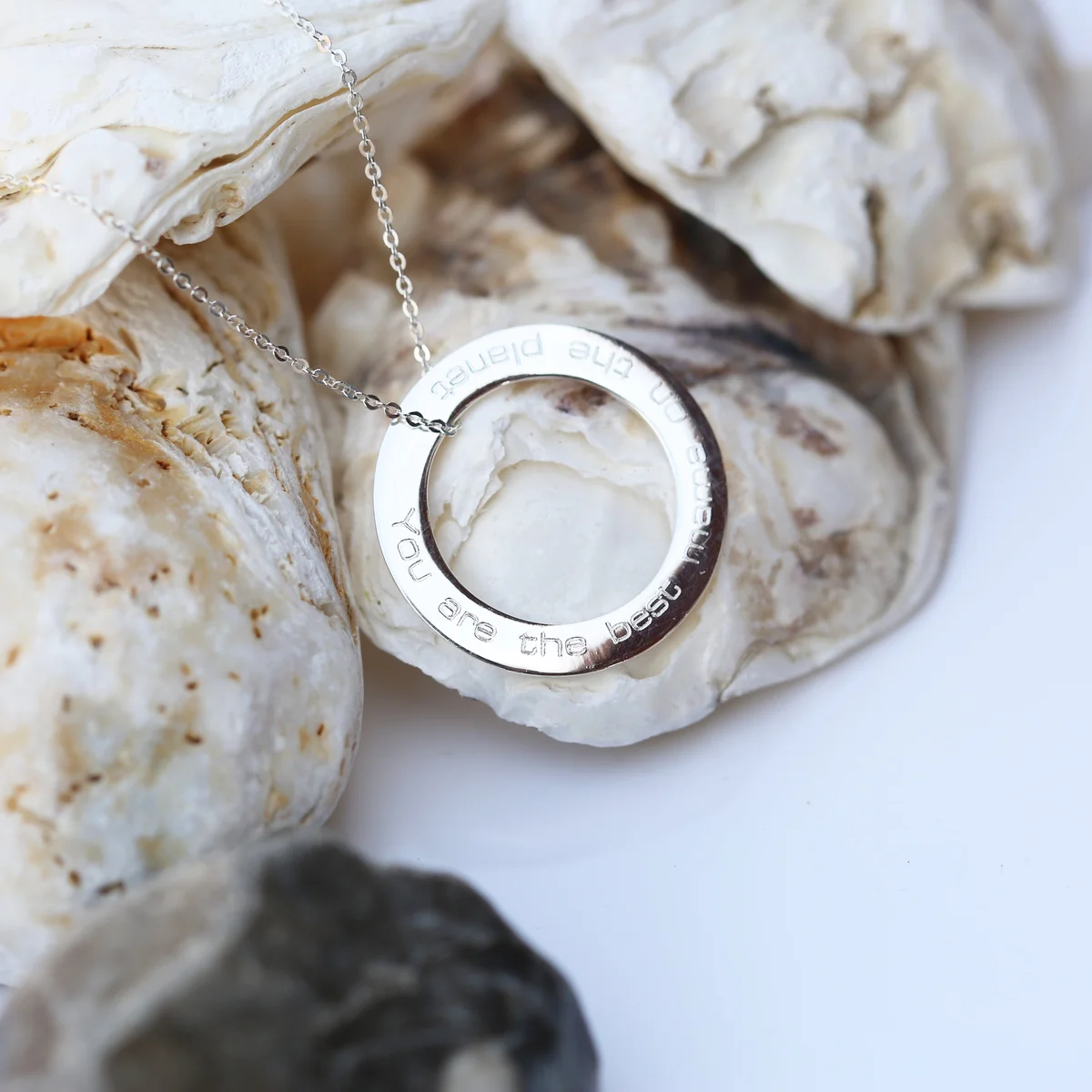 Sterling silver engraved silver necklace with circular halo pendant on fine Italian 42cm chain displayed on white background