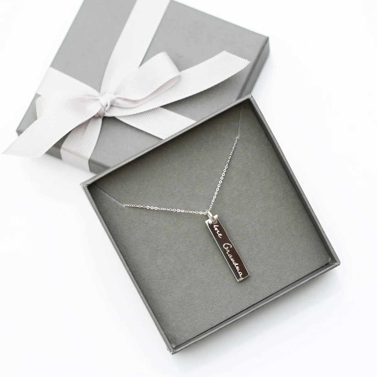 Sterling silver bar necklace with engraved handwriting on the pendant, carried by fine sterling silver chain.