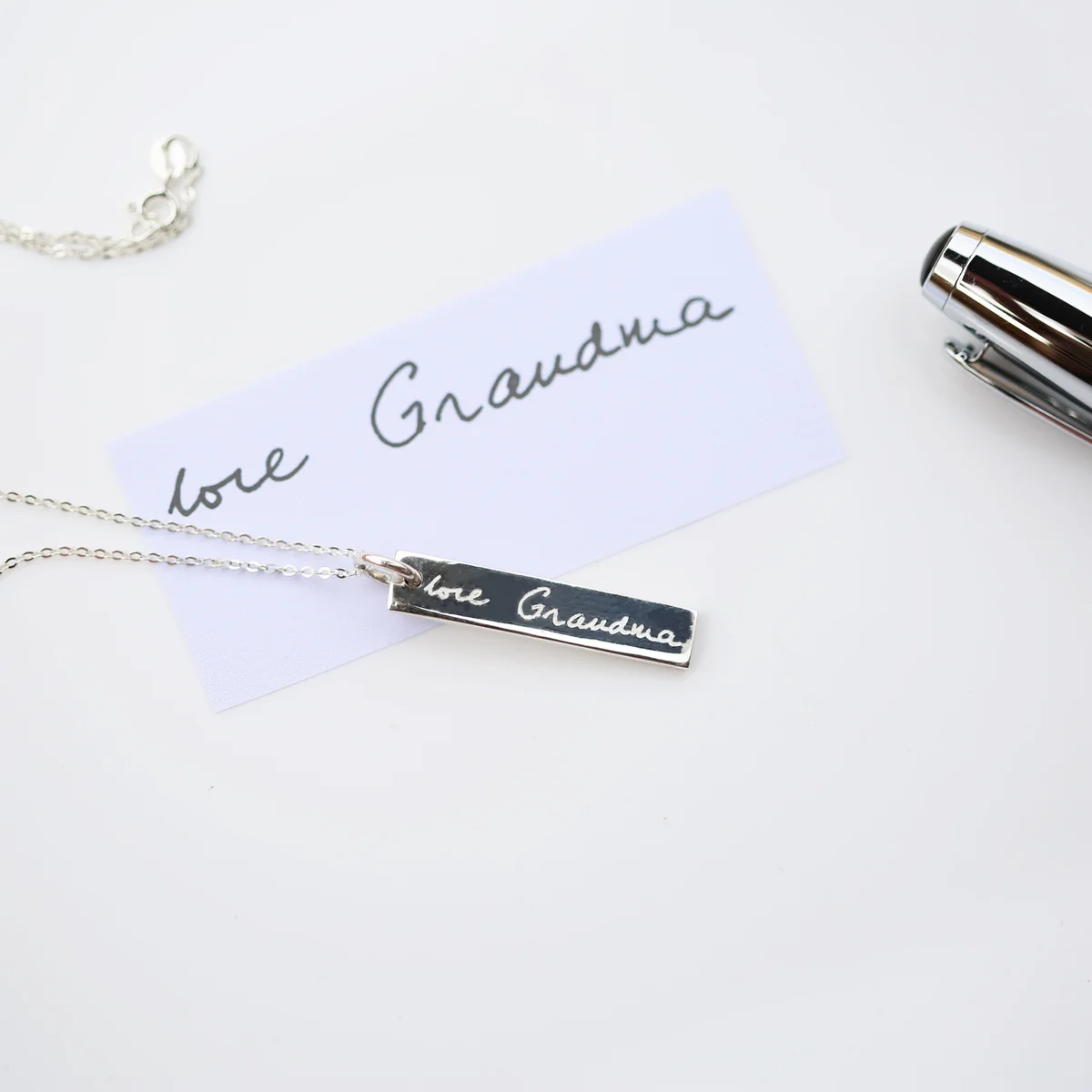 Sterling silver bar pendant on fine chain, lightly engraved with your personal handwriting – a personalised handwriting necklace.