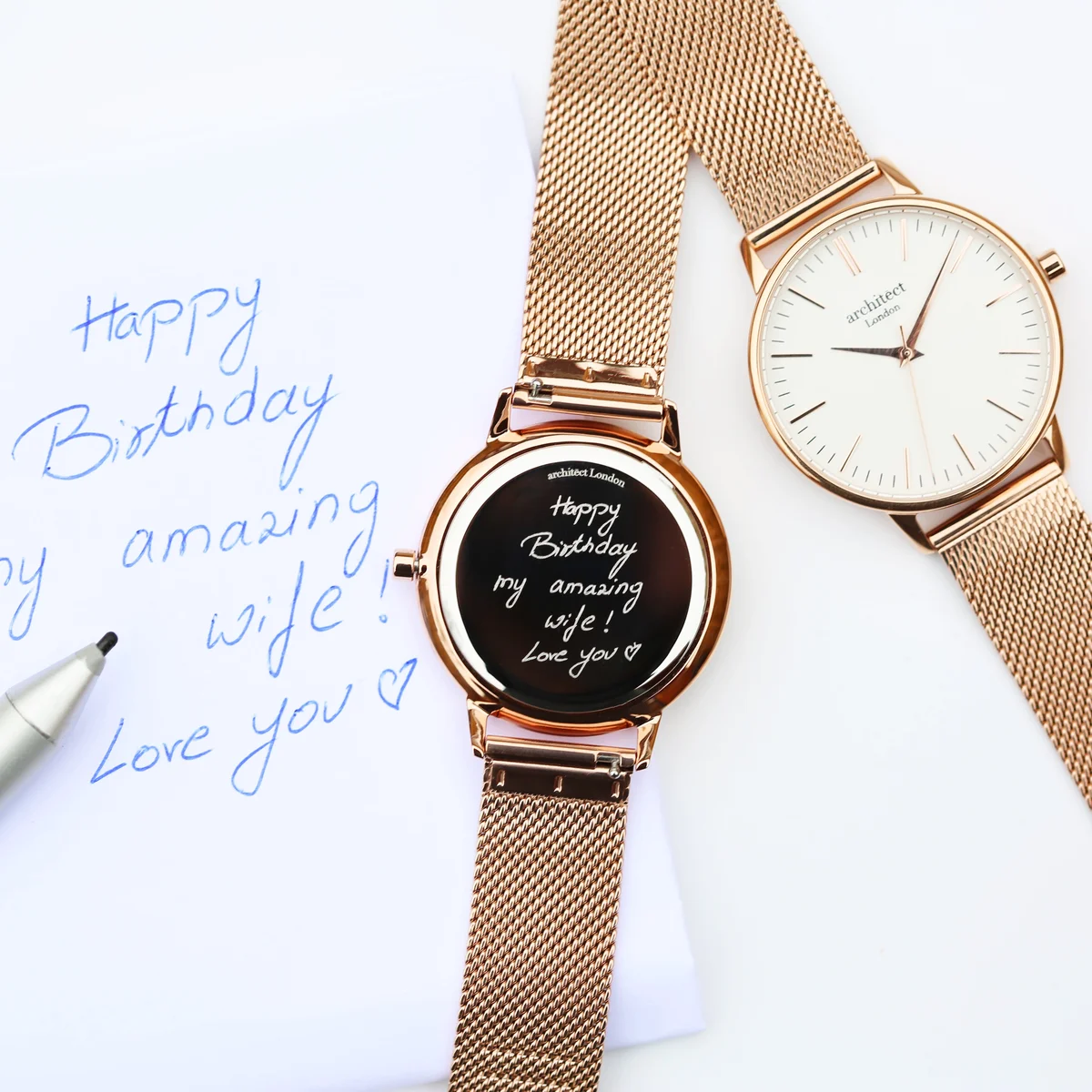 Ladies Architēct Blanc watch with minimalist white dial and elegant rose gold mesh strap against white background