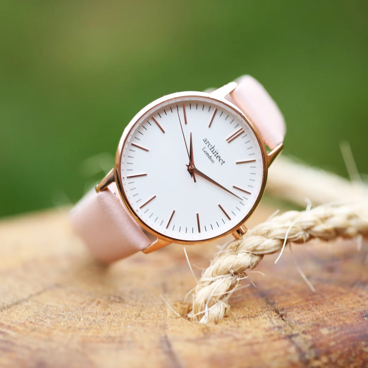 Ladies Architēct Blanc handwriting engraving watch with light pink leather strap and stainless steel case on white background