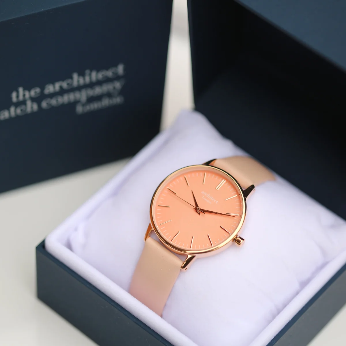 Ladies Architēct Coral handwriting engraved watch with apricot coral dial and light pink genuine leather strap on white background