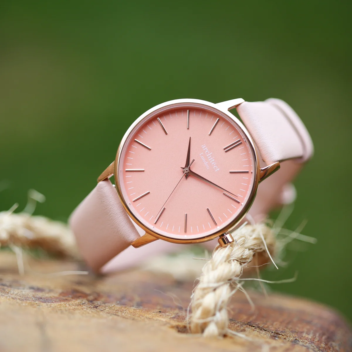 Ladies Architēct Coral watch with apricot coral dial and light pink leather strap on white background