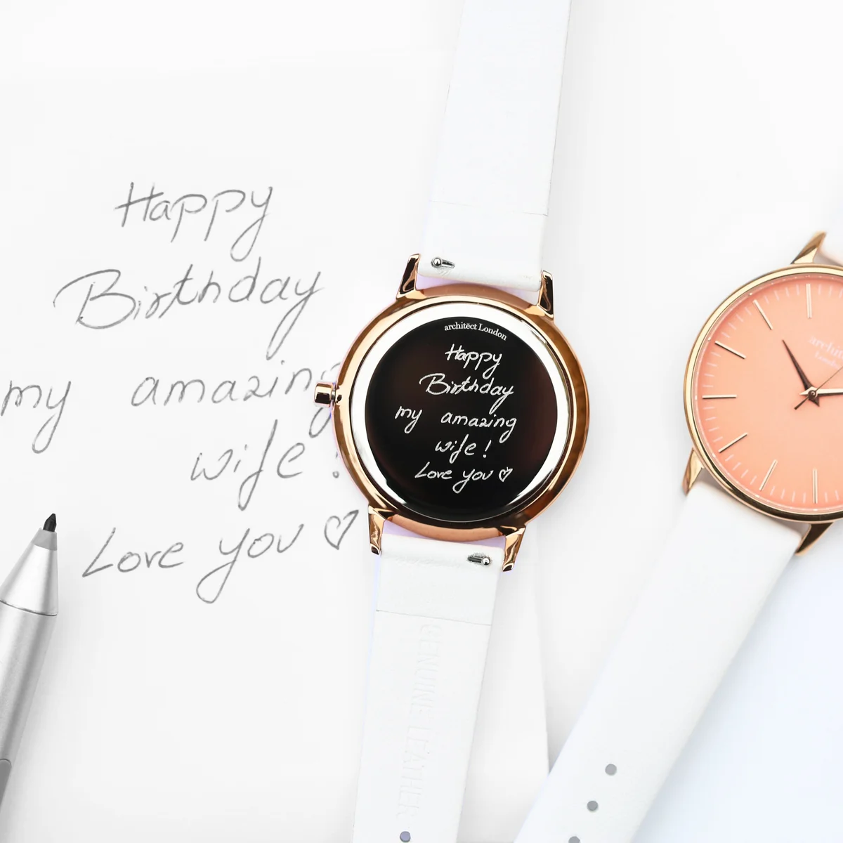 Ladies coral watch with apricot dial, polished stainless steel case, and white genuine leather strap on white background