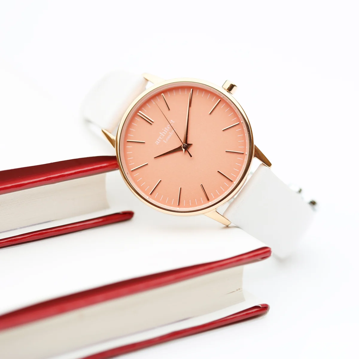 Ladies Architēct Coral watch with apricot coral dial and white leather strap watch on a white background